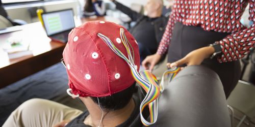 A student demonstrates how an EEG is performed in a Psychology class