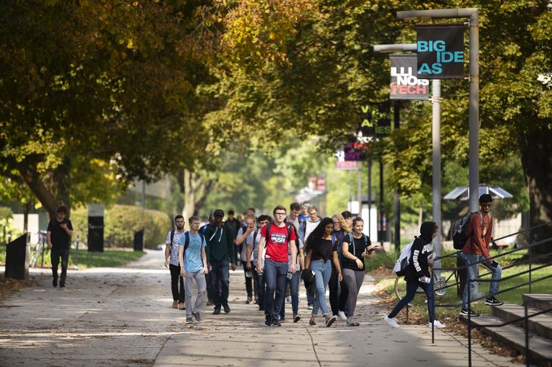 Students walk to class down the main stretch of campus
