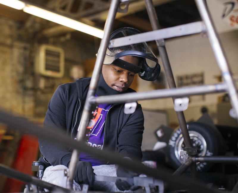 An Armour College of Engineering student works on racecar