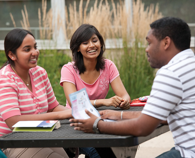 Multiple international students having a conversation outside on Mies campus