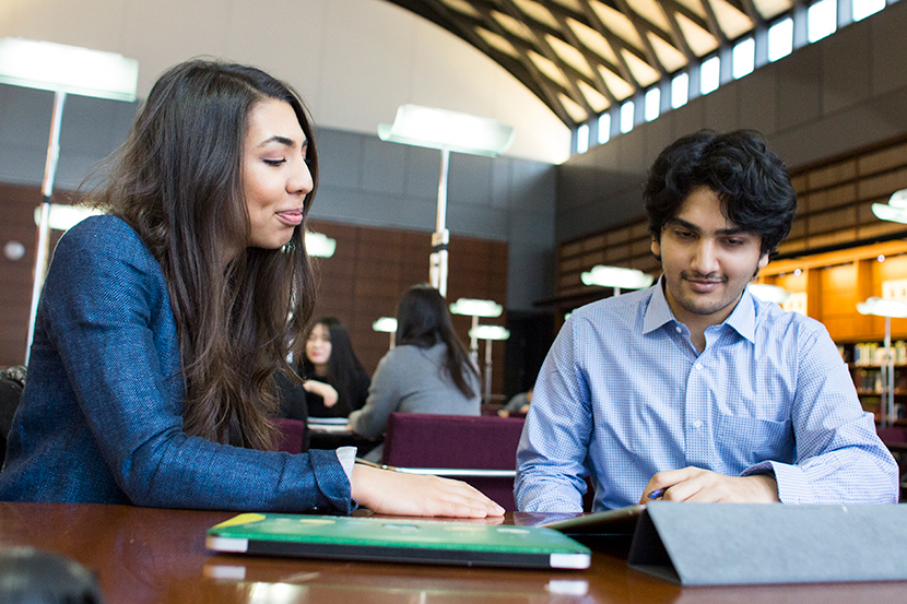 Two graduate students inside the Chicago-Kent Law library