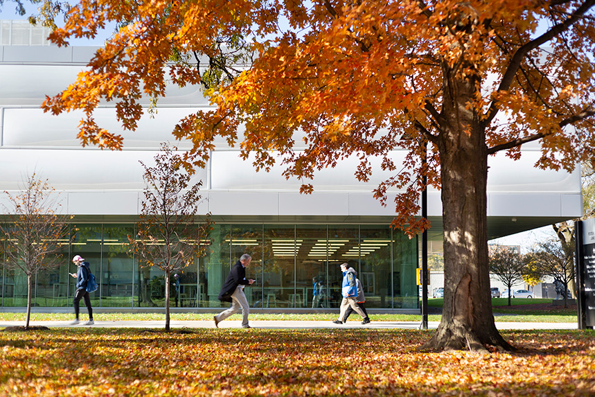 People walking outside in the fall weather on Mies Campus