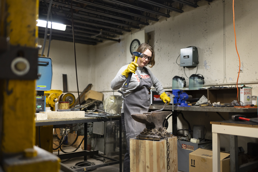 A student group, Materials Advantage, works to create a blade in a smithing shop