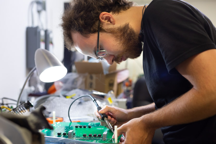 Photo of electrical engineering graduate student at work in a lab