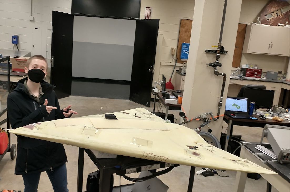 Photo of Rosemary Johnson with an aircraft in the lab