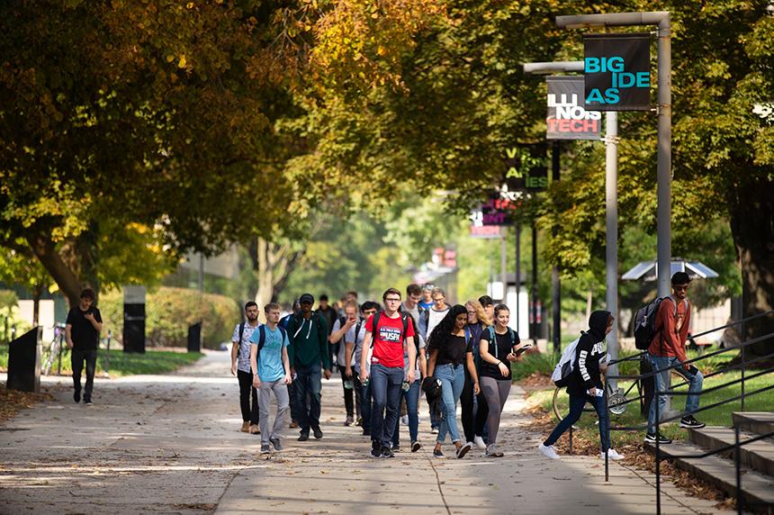 Multiple students walking on Footlick Lane on Mies Campus