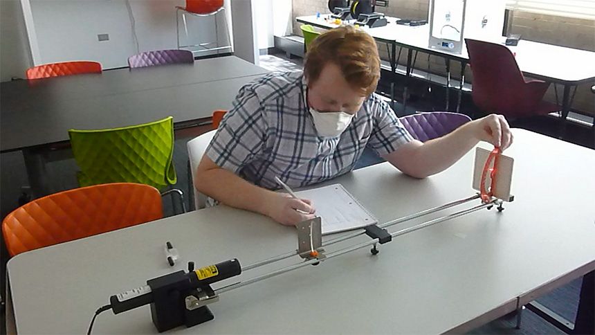 student working at desk testing lens