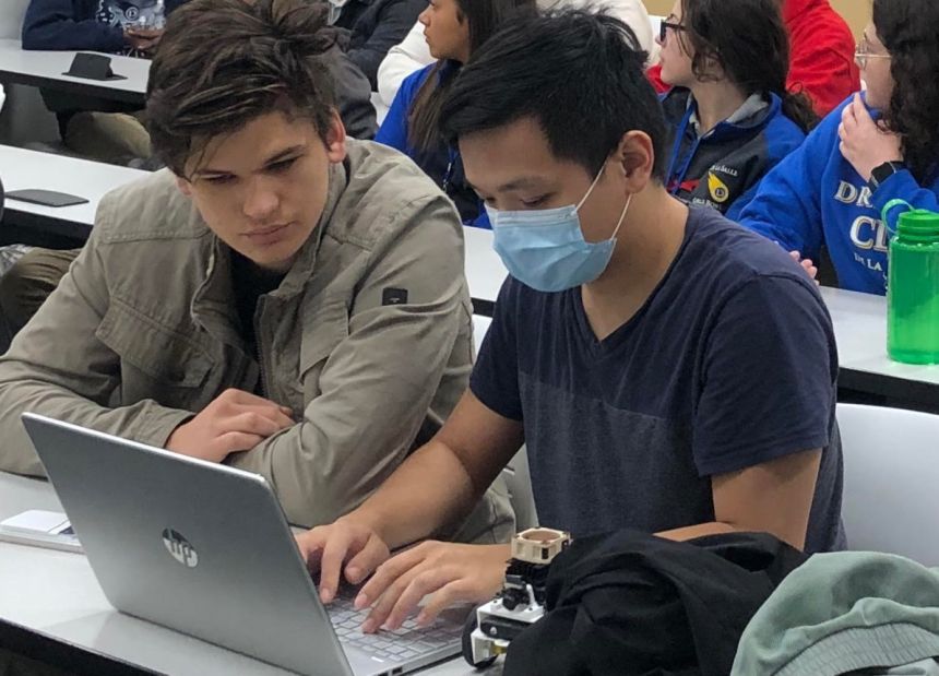 Two high school students working on a laptop during STEM Cafe