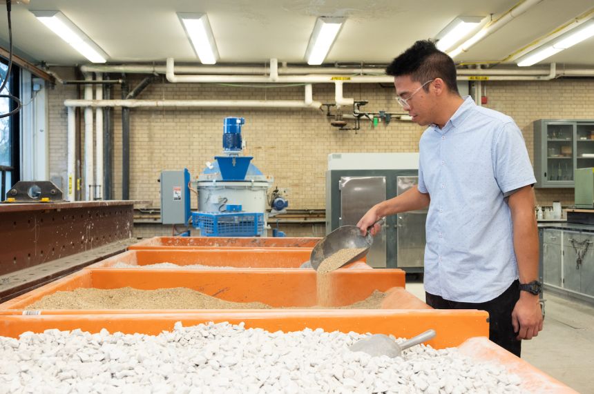 Kurt Ordillas (CE/M.Eng. TE ’20, Ph.D. CE Candidate) with bins of concrete aggregates in the Concrete Materials and Structures Lab.