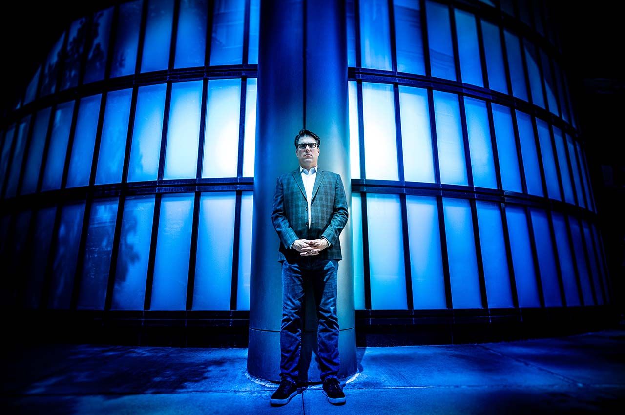 A portrait of Daniel Martin Katz against a blue backdrop
