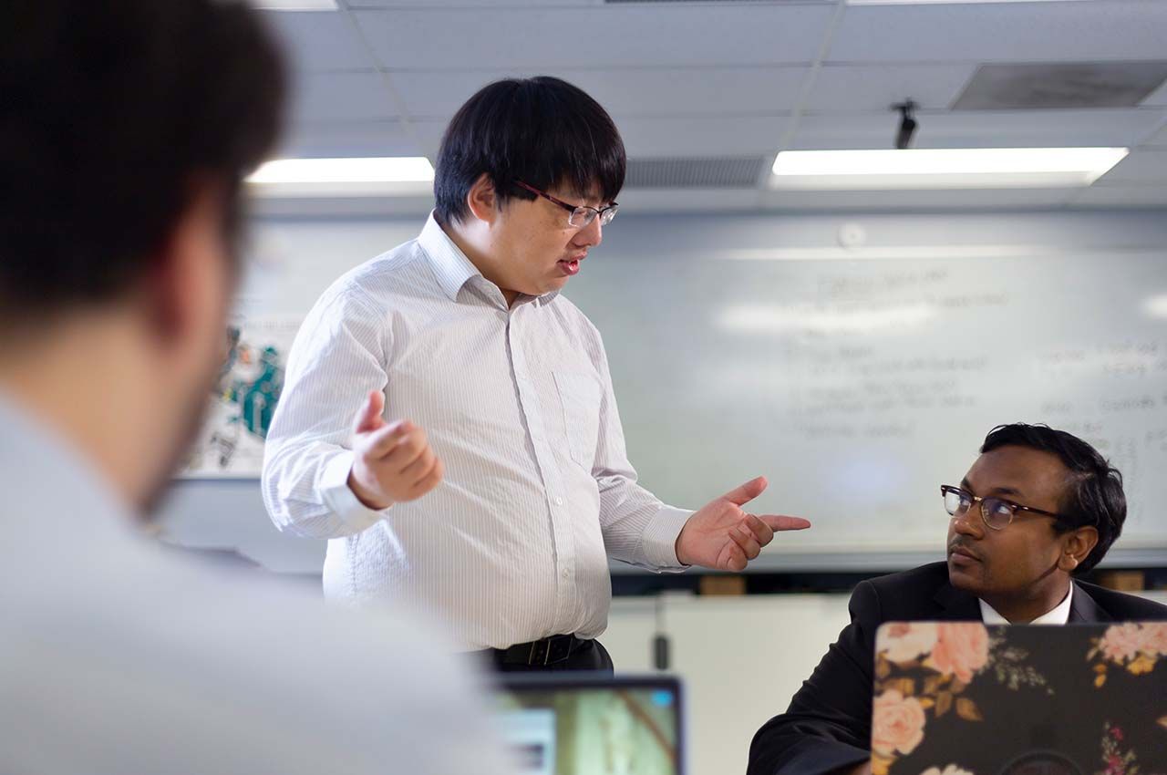 Assistant Professor Yong Zheng talks with a student