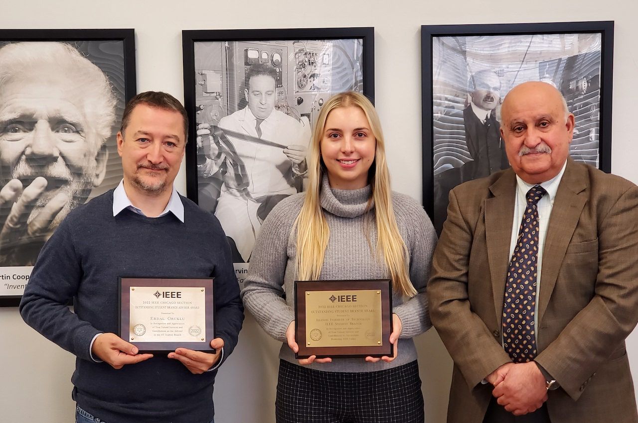 Erdal Oruklu and Chloe Rubinowicz holding award plaques, Jafar Saniie