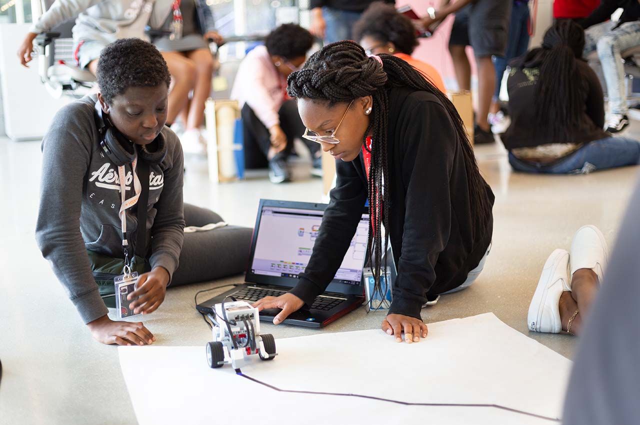 Students taking part in SMASH work with robotics at Kaplan Institute
