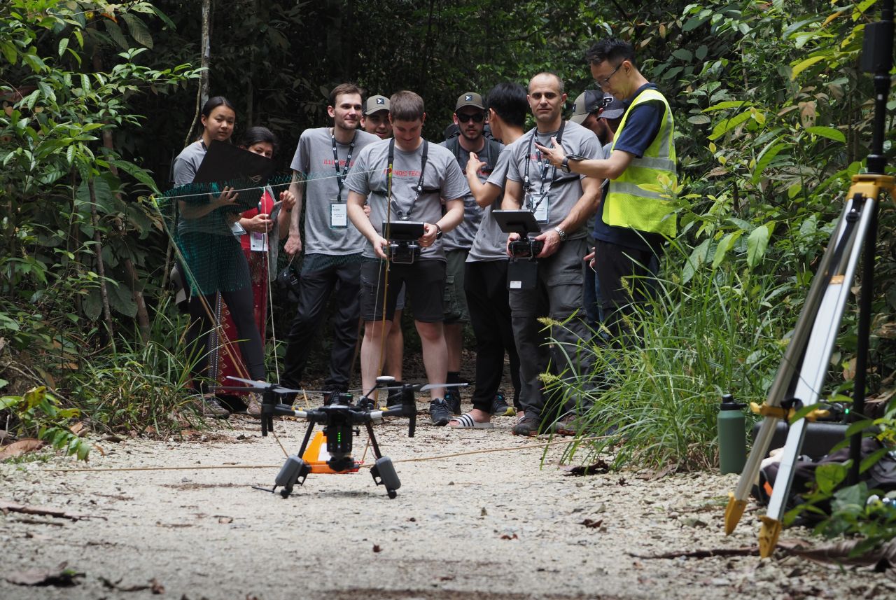 Professor Matthew Spenko, second from right, looks at team Welcome to the Jungle’s drone, along with a member of the XPRIZE organizing team, in the vest, and several students from Illinois Institute of Technology. The Illinois Tech students are, from left, Naia Lum (MMAE 4th Year), Patrick Grider (MMAE 4th Year), Ethan Jennsen (MMAE 3rd Year), David Cañones Bonham (MMAE Ph.D. Student), Patrick Dunne (MMAE 4th Year), and Khang Pham (MMAE 3rd Year), looking away from camera. (Photo credit: Cat Kutz/XPRIZE)