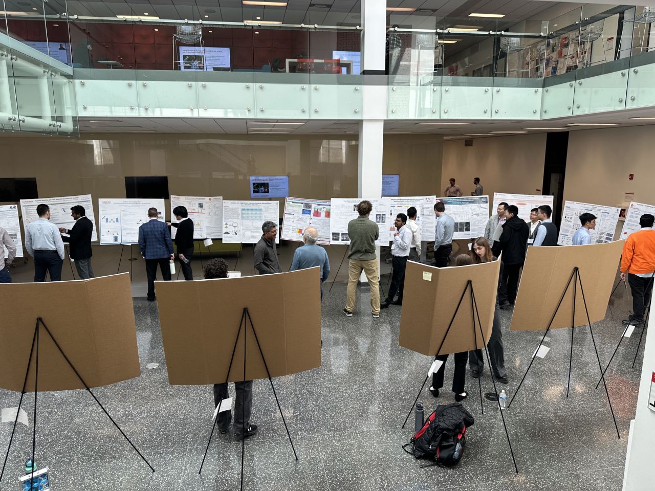 Image of MMAE Poster Competition participants looking at submitted posters