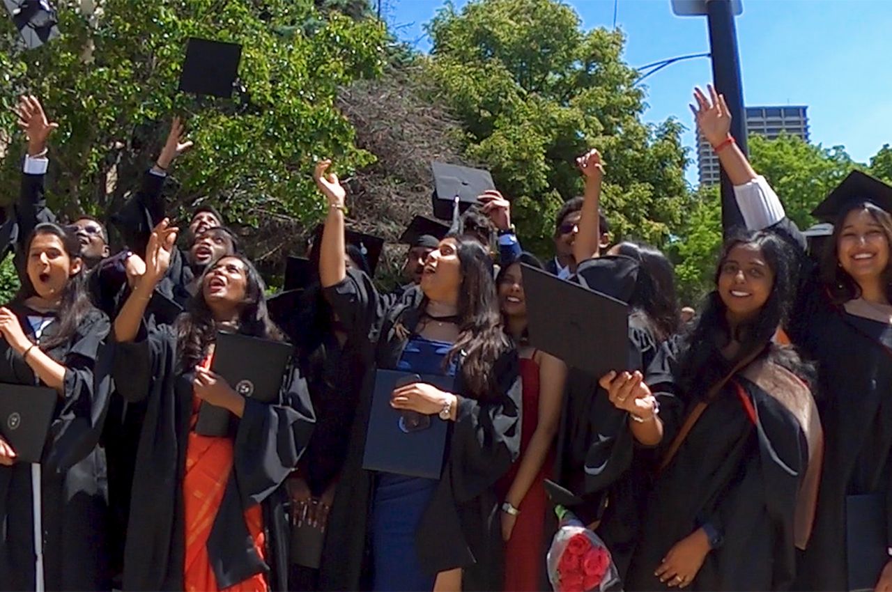 Illinois Tech graduates throw their hats in their air after graduating on May 16, 2026