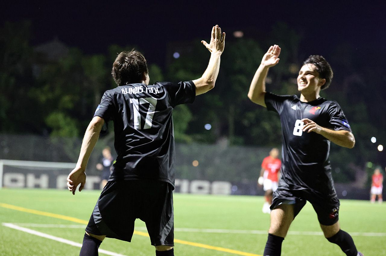 Illinois Tech men’s soccer players Tomas Rebelatto (17) and Theo Balea celeberate