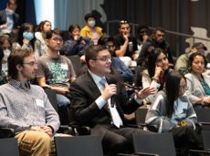 Professor sitting in group of students speaking on lecture at Illinois Tech