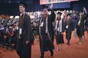 Students waving at Illinois Tech's 2024 Commencement