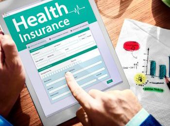 Close-up of person holding and reviewing health insurance form