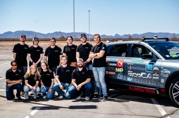 Image: Illinois Tech EcoCAR team posing in front of their car at vehicle testing week in Yuma, Arizona.
