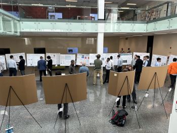 Image of MMAE Poster Competition participants looking at submitted posters