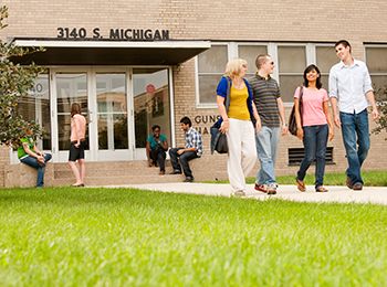 Students walk in front of Gunsaulus Hall, a residence hall at Illinois Tech