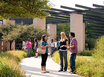 Students standing in front of McCormick Student Village a residence hall at Illinois Tech