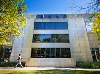 A student walks in front of Rowe Village, a residence hall at Illinois Tech