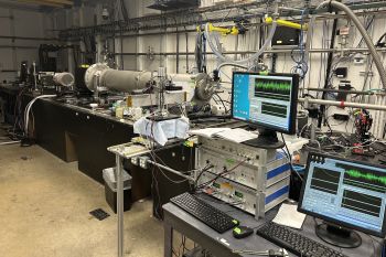A laboratory work area with computers and scientific equipment.