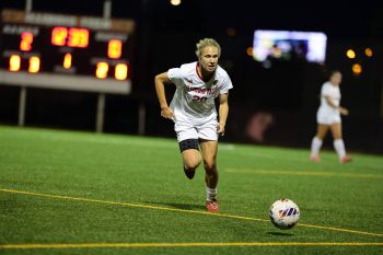 Illinois Tech women's soccer player Kayla Thomas kicks the ball at Stuart Field