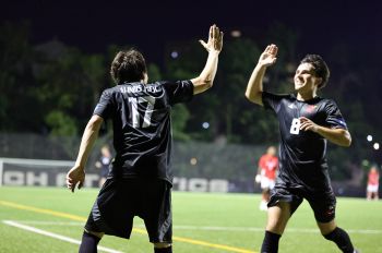 Illinois Tech men’s soccer players Tomas Rebelatto (17) and Theo Balea celeberate