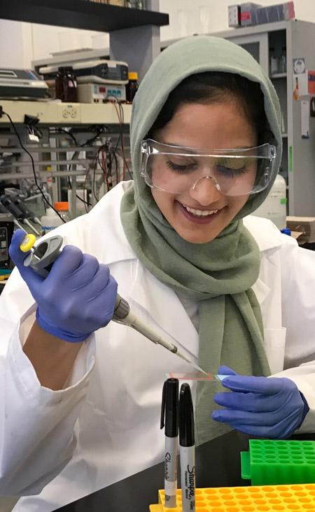 Photo of student Anam Adil in the lab