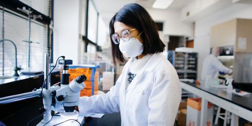 Graduate female student working in a science lab