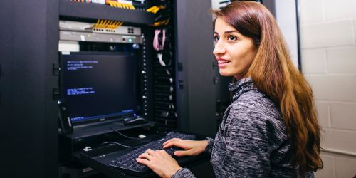 Female student works on the interface in the Department of Information Technology and Management server room