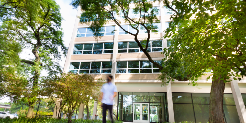 Kacek Hall Exterior framed by trees