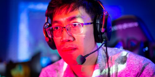 Illinois Tech alum Elvin Moy plays a video game in the university's esports room