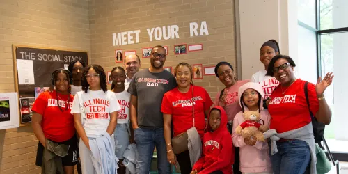 A photo of a student and their family