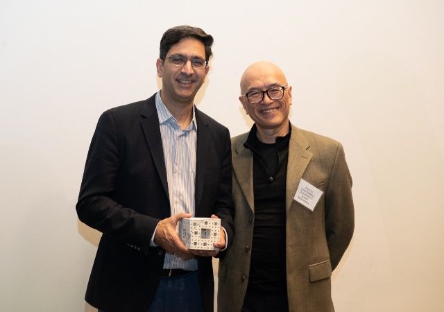 Lior Patcher holding the Menger sponge with Applied Mathematics Chair Chun Liu