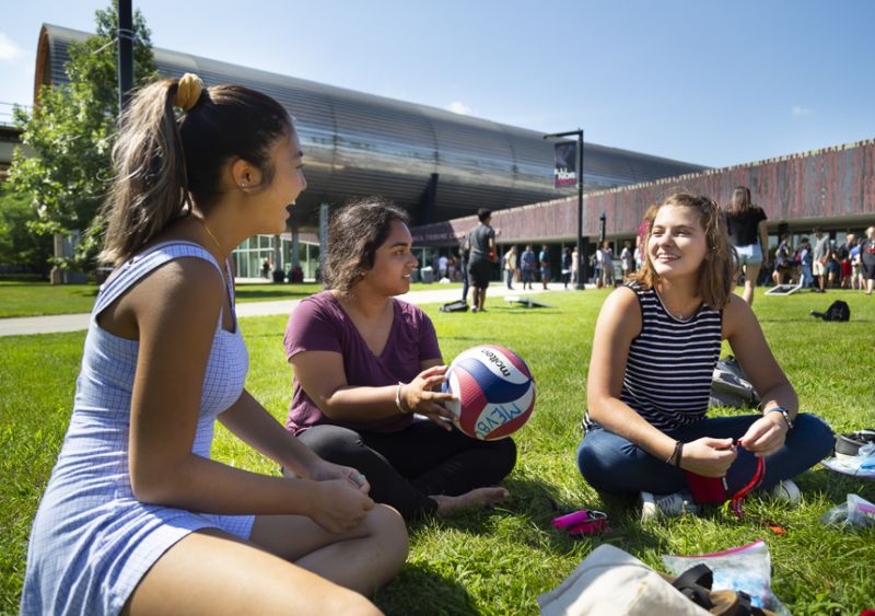 Three students hang out outside of MTCC