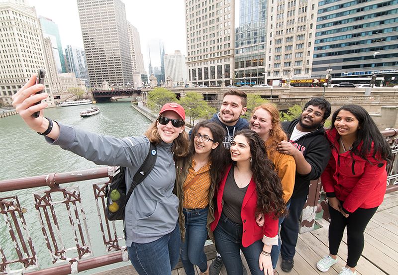 Multiple undergraduate students taking a selfie in downtown Chicago