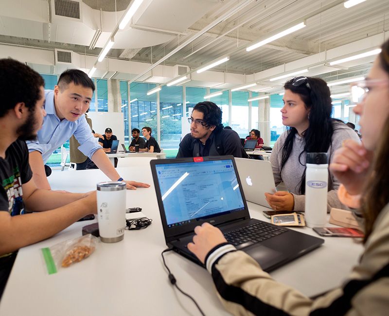 Students discuss an IPRO at a table in Kaplan Institute