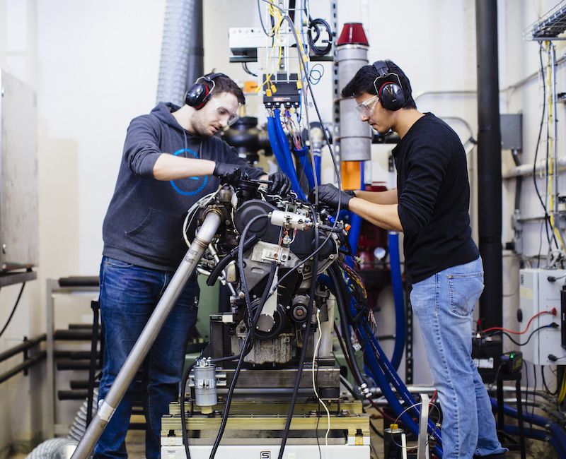 Students work on an engine in the lab