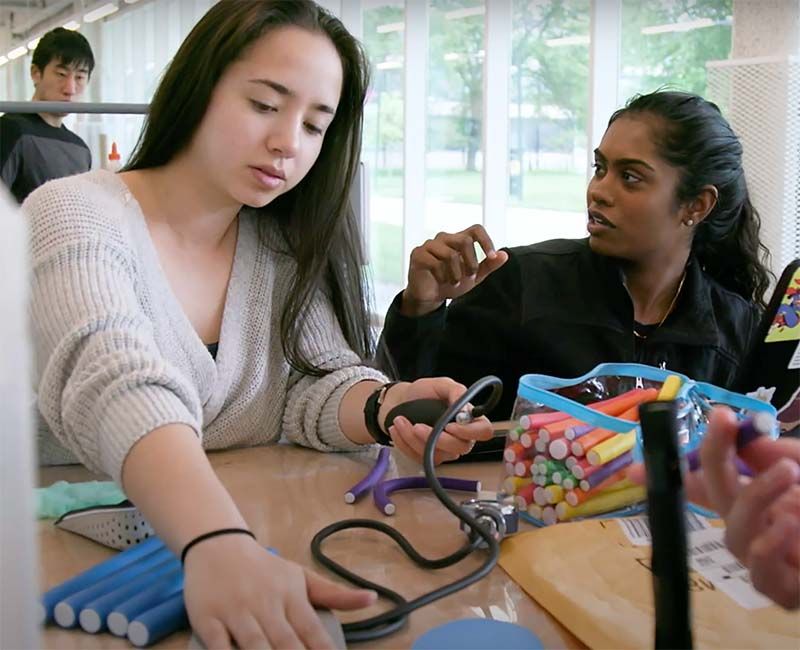 Still from the IPRO video showing two students working on a project