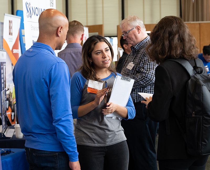 On campus career fair with employers talking to student