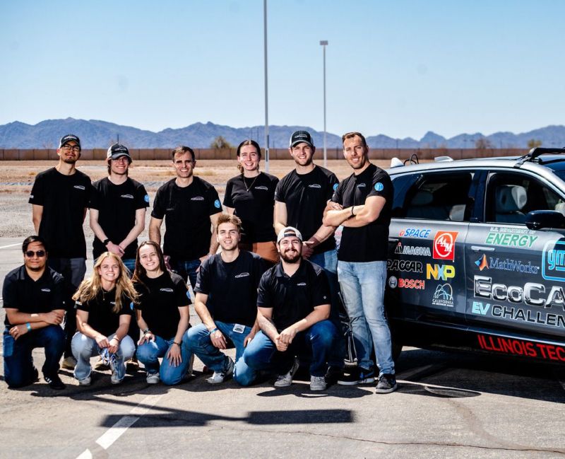 The 13 members of Illinois Tech's EcoCar team pose with the car at an Arizona test track