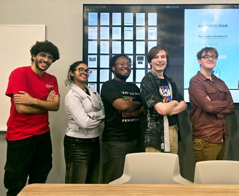 CyberHawks students stand in hero poses while visiting Baldwin Wallace University in Berea, Ohio