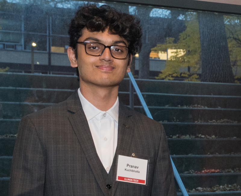 Pranav Kuchibhotla stands in front of a staircase at the MTCC
